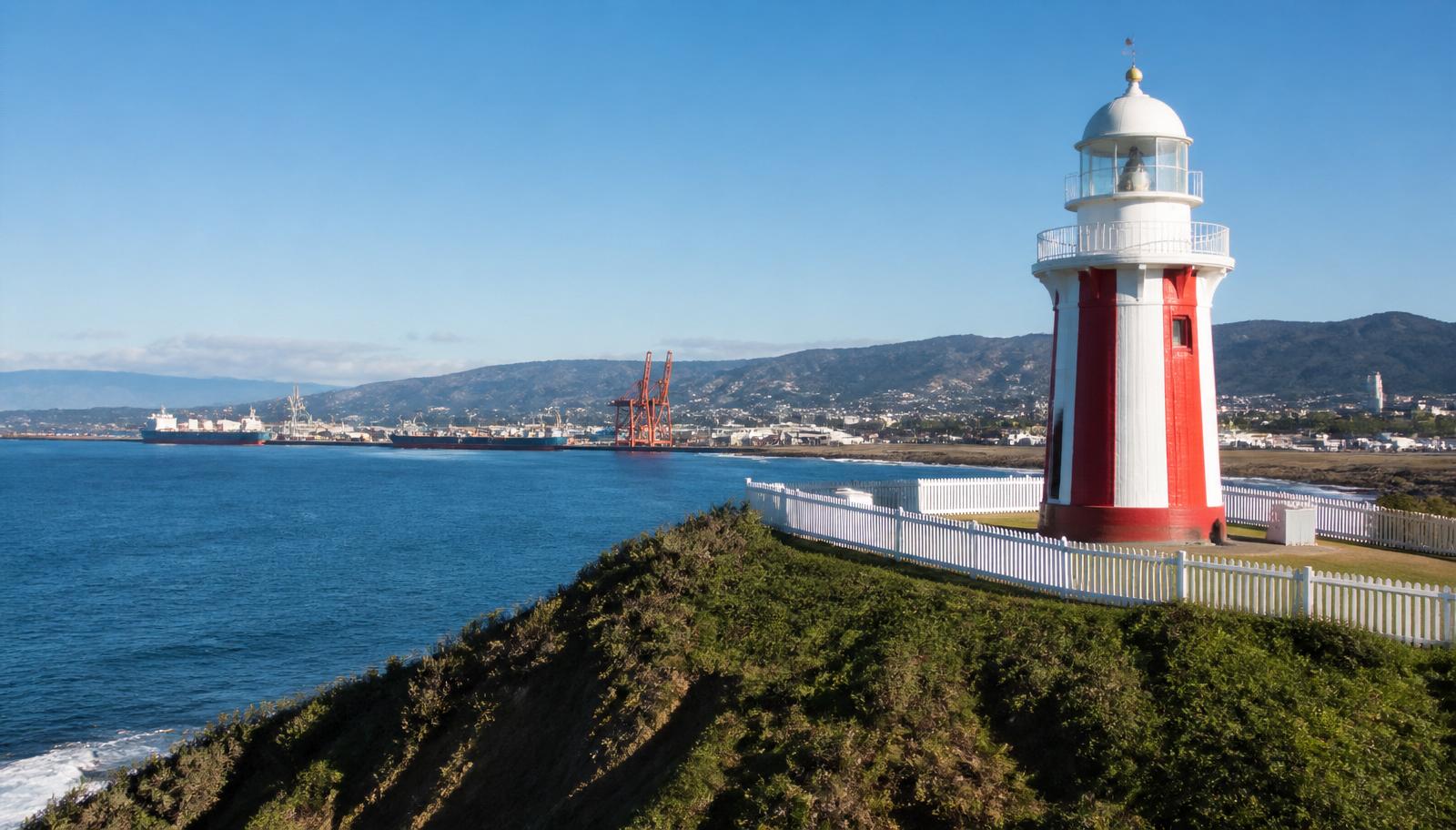Licensed plumber and electrician servicing Berkeley — the historic Port Kembla lighthouse above the port and industrial foreshore, Wollongong NSW.